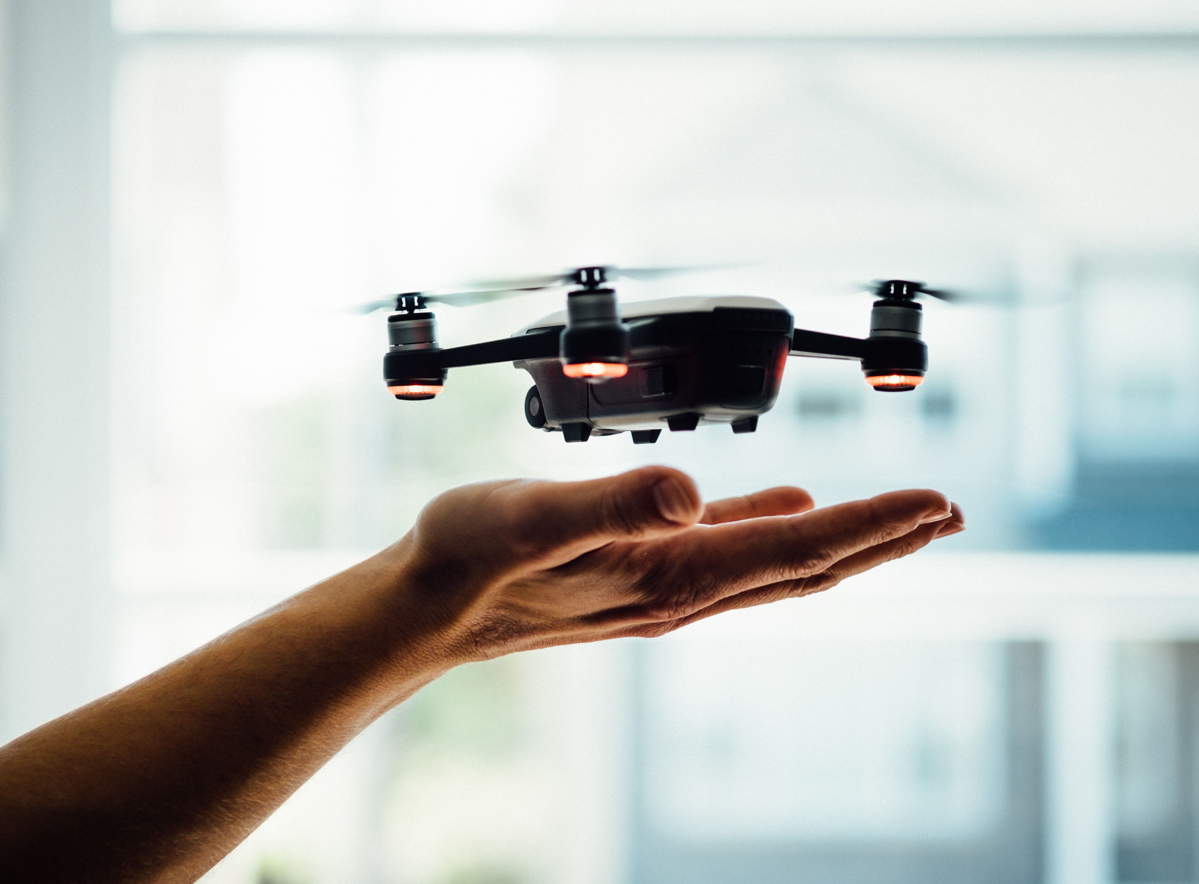 drone hovering above hand