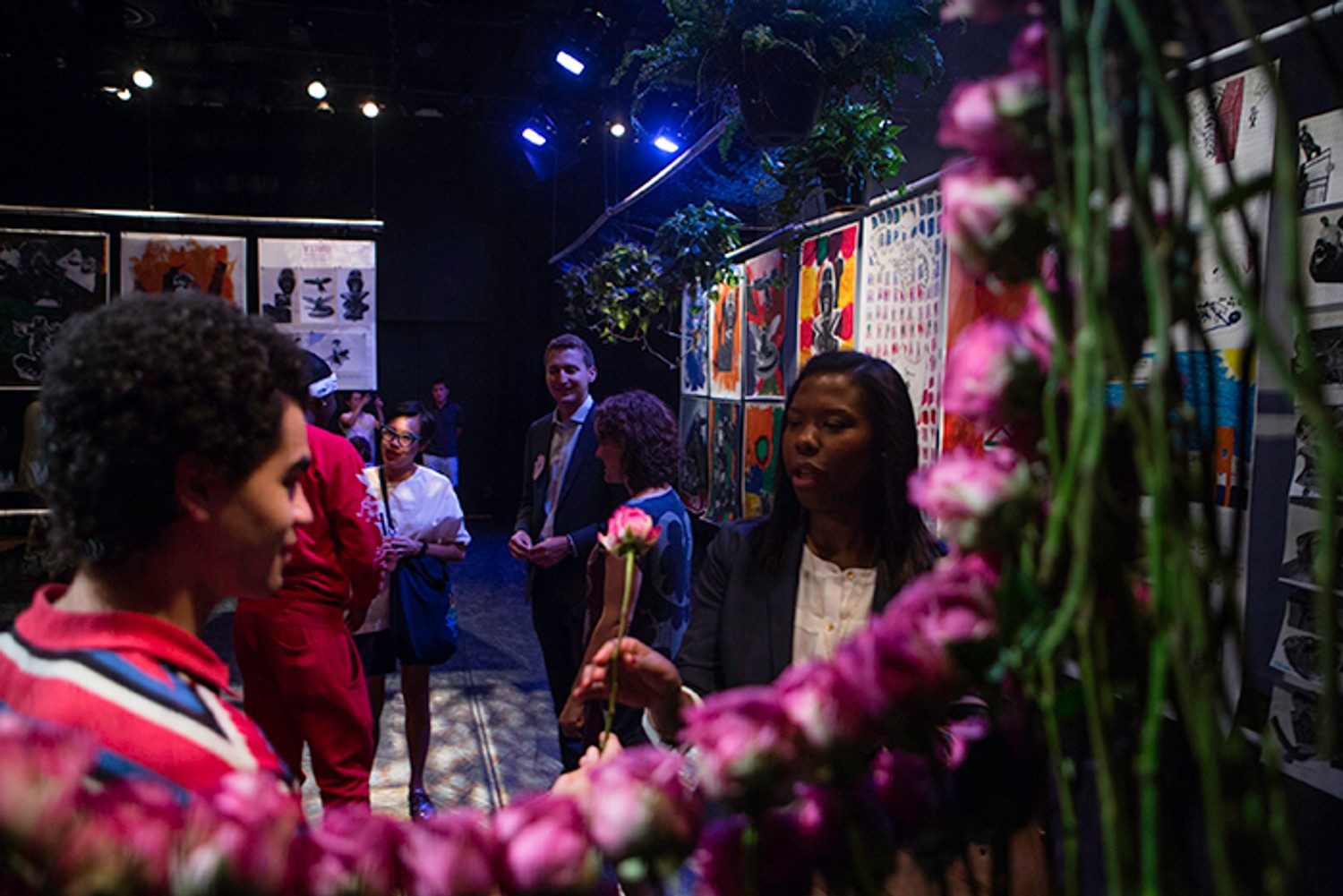 One of the participants who designed UNITY: Visions for Neighborhood Policing gives the prosecutor who sentenced him to the program a rose in exchange for her vision for policing. Photo: Mansura Khanam. 