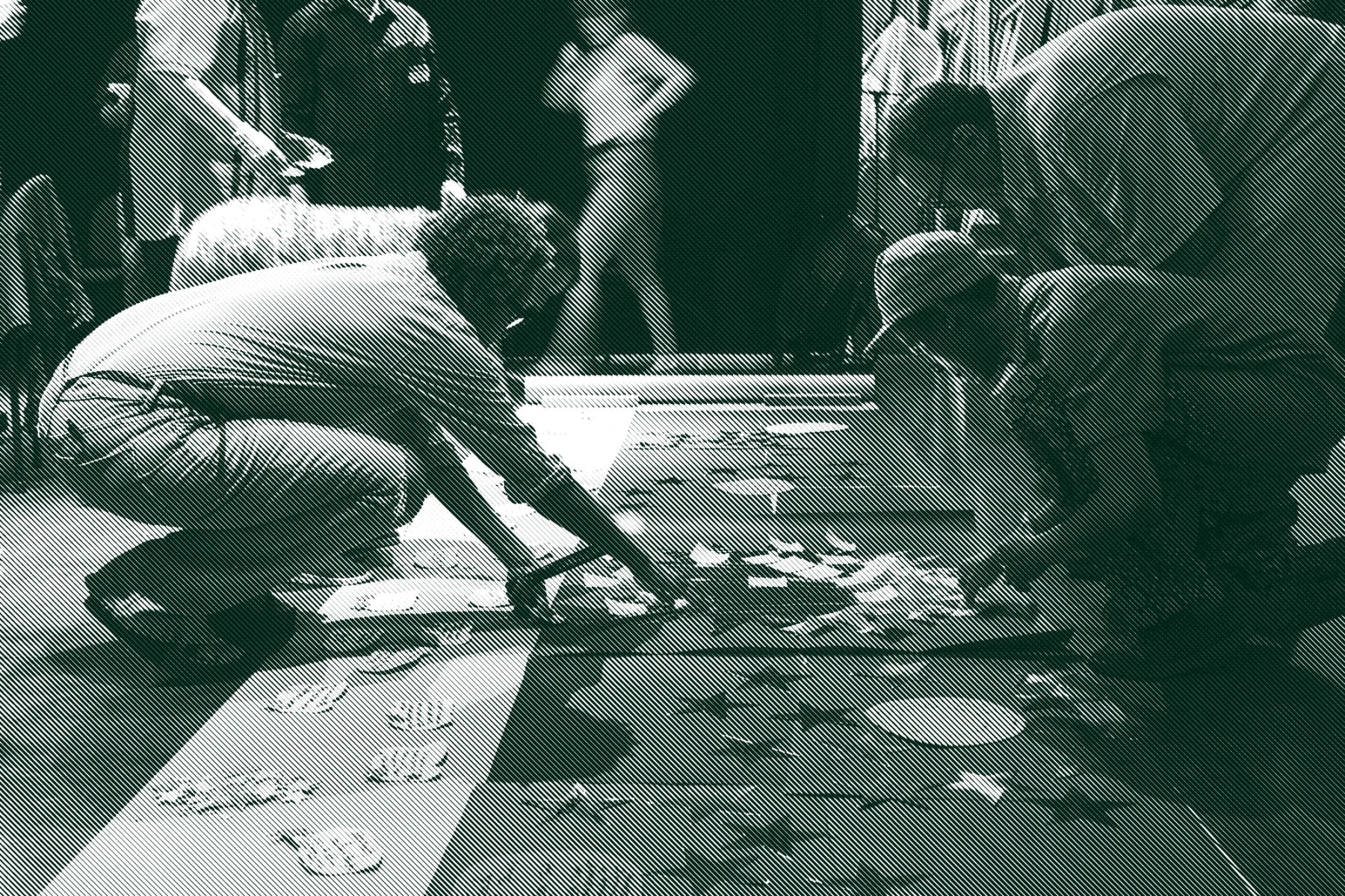 Four people kneel over posters with large cut out stars on the ground and engage in an acitivty together.