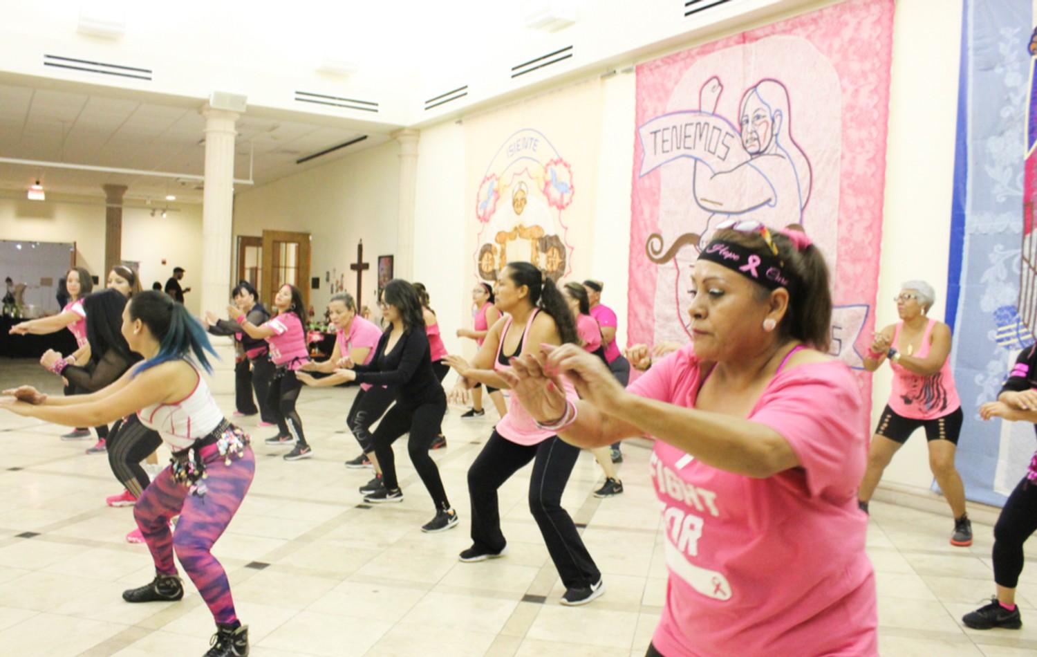 Resistance Resilience and Remembrance, 2017. Women dance in front of two large fabric murals that portray community immigrant rights activists in the Rio Grande Valley. The dance and murals were on view as part of an exhibition commemorating 100 years since La Matanza, when Texas Rangers killed hundreds if not thousands of Mexican Americans in South Texas. Produced in partnership with the Refusing to Forget project. Image: Christina Patiño Houle.