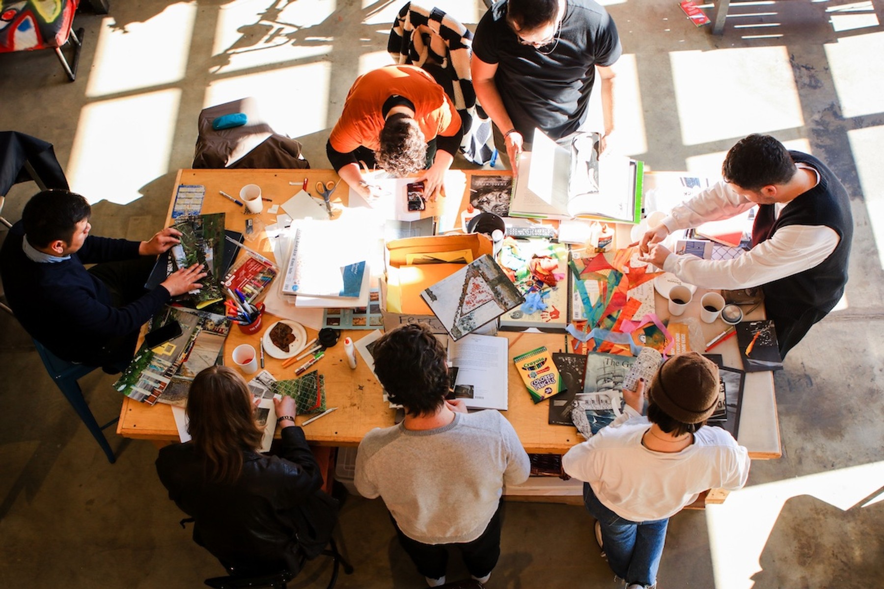 Aerial view of UNDOC+Collective members and guests creating zines at Visible Records.