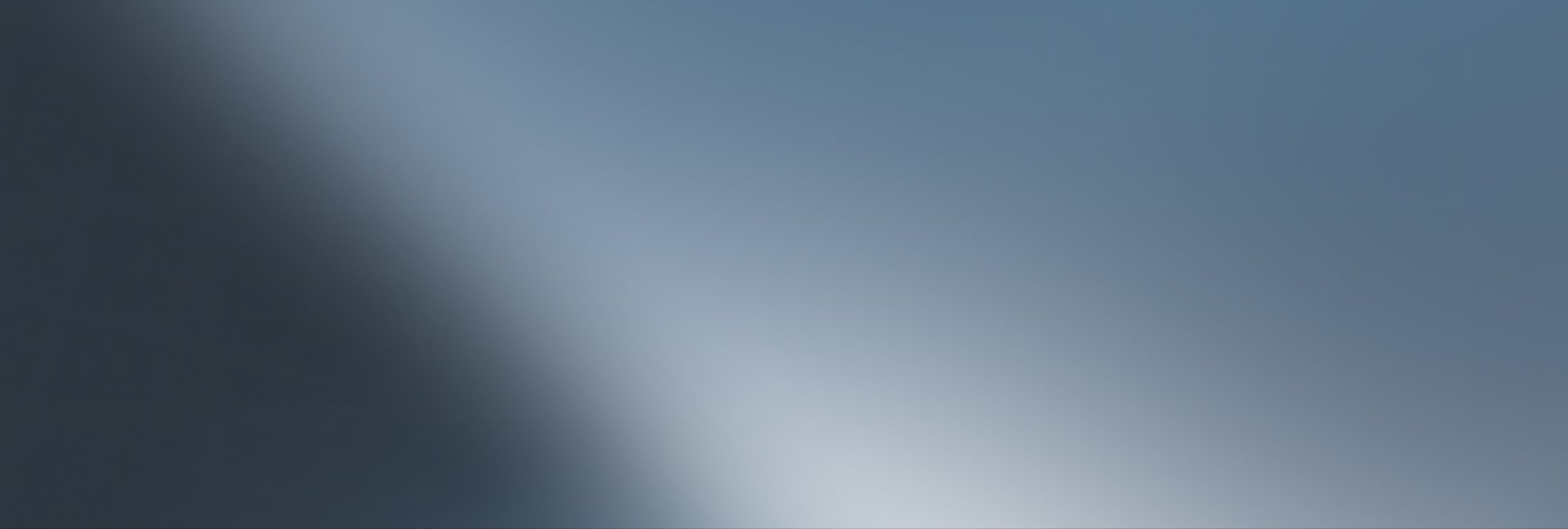 Gradient background from dark blue-grey to light blue-grey with a diagonal bright sheen.