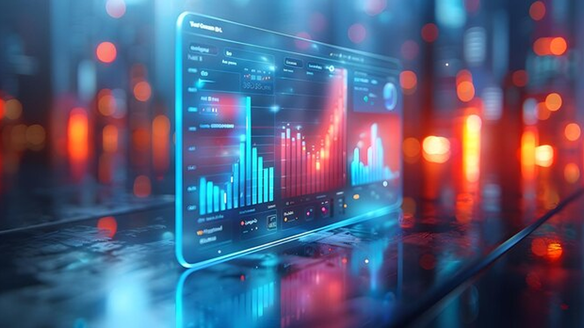 A futuristic transparent screen displays glowing blue and red data charts and graphs against a blurry city background.