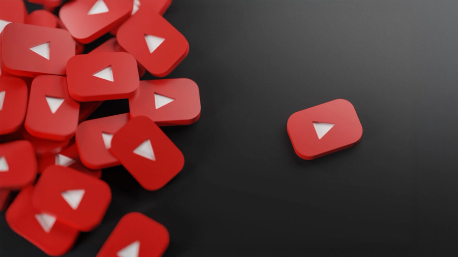 Multiple red YouTube play button icons scattered on a dark background.