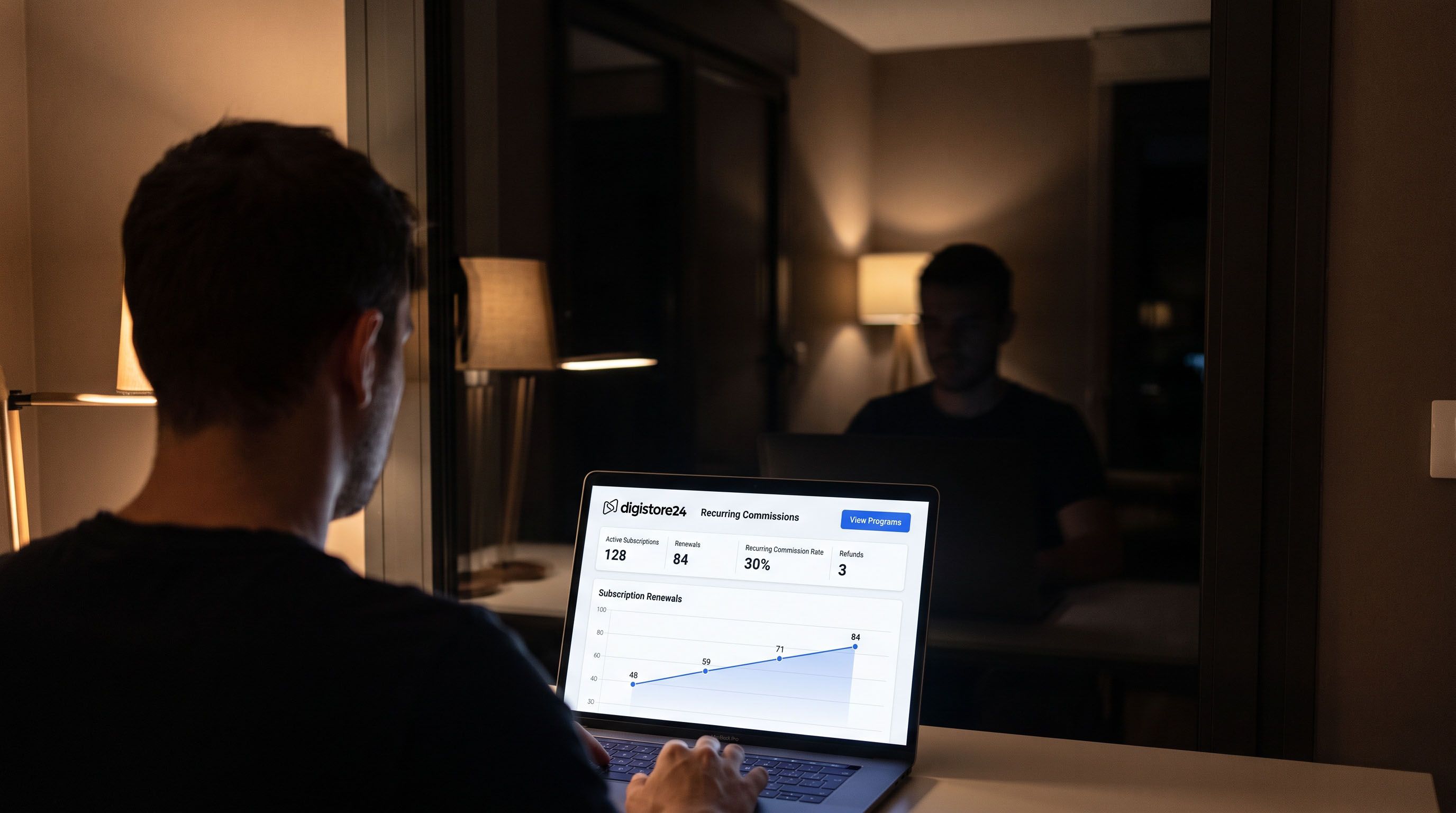 A person views Digistore24 analytics on a laptop in a dimly lit room.