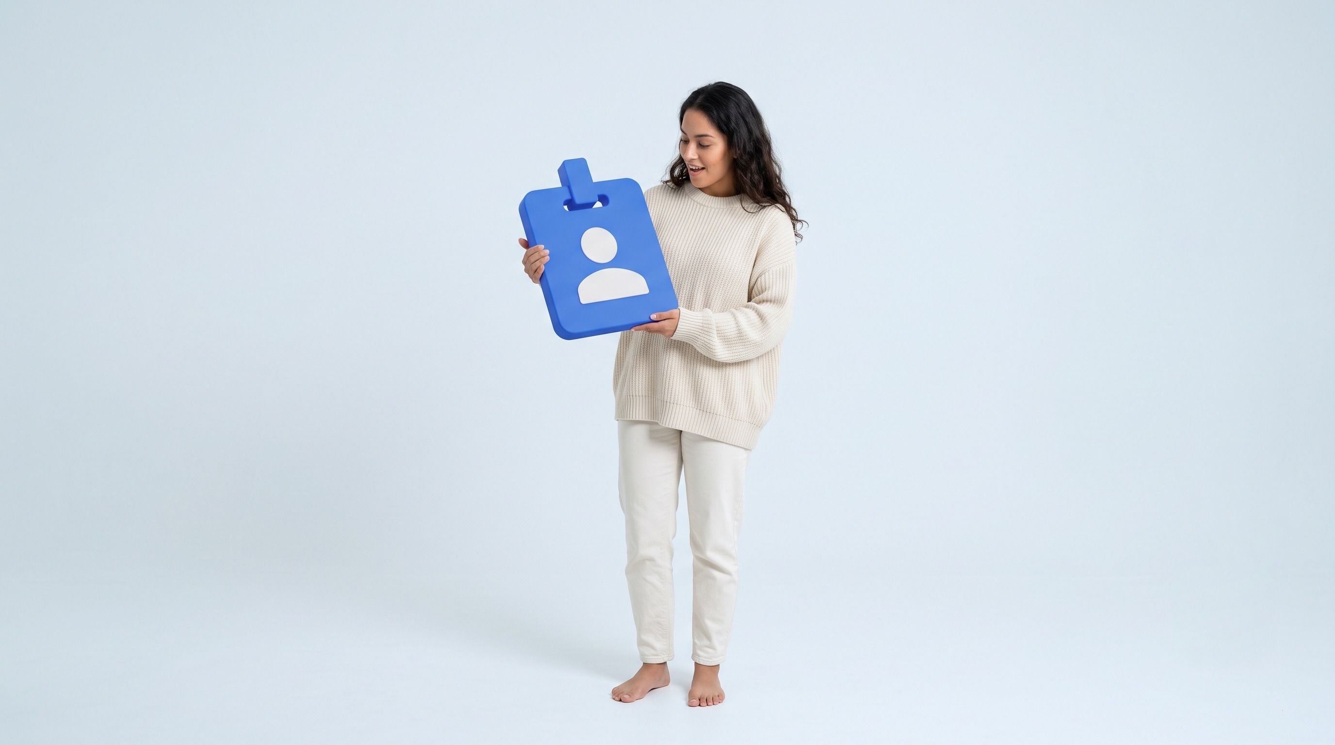 A smiling woman holds a large blue ID card icon with a white person silhouette.