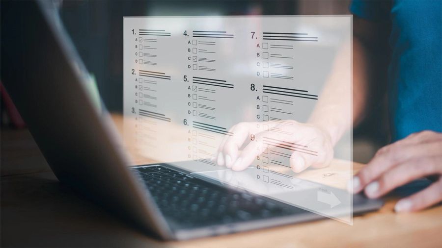 Hands interact with a laptop, featuring a translucent digital questionnaire overlay.