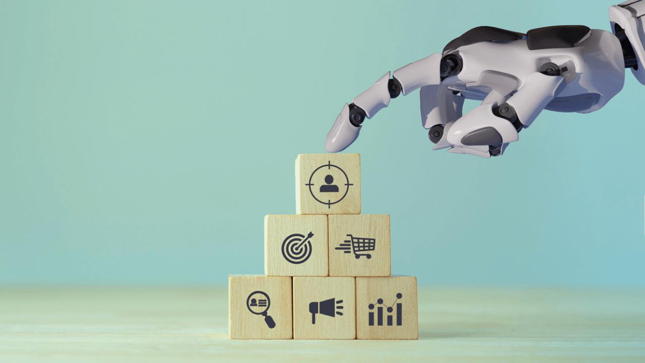 Robotic arm points to a customer target icon block atop a pyramid of marketing strategy symbols.