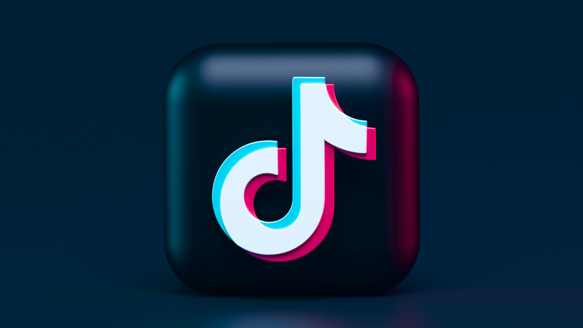 3D TikTok logo with cyan and magenta accents on a dark background.