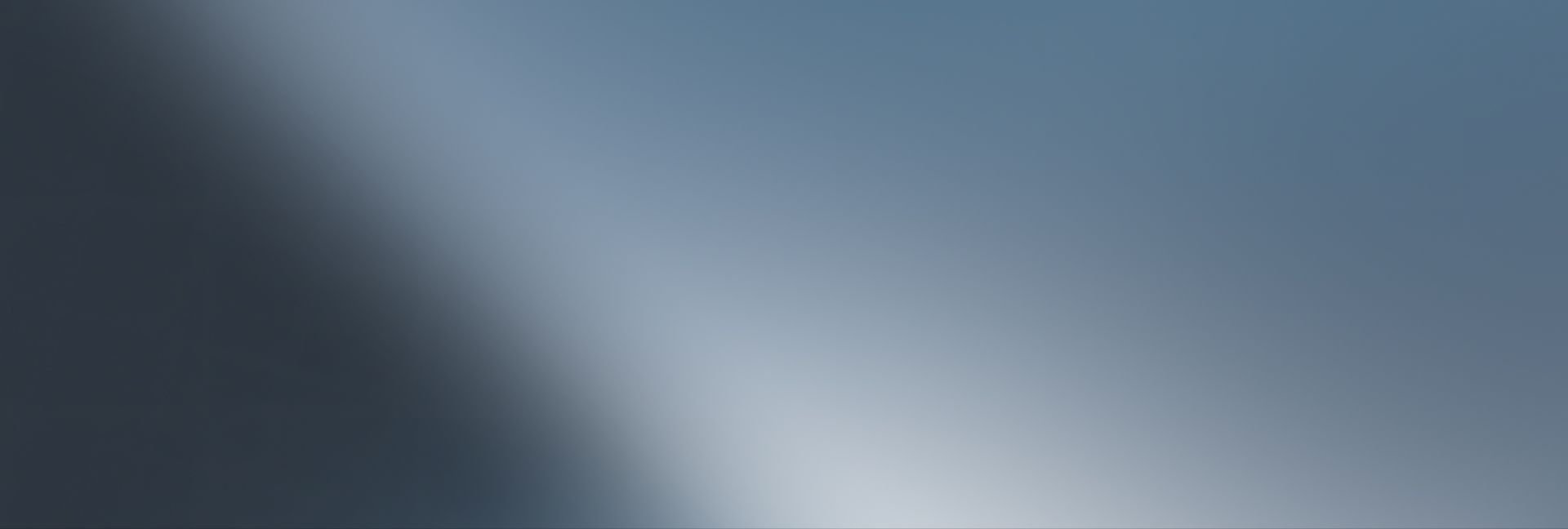 Gradient background from dark blue-grey to light blue-grey with a diagonal bright sheen.
