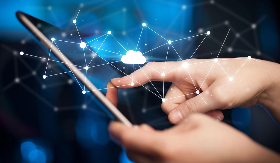 Hands holding a tablet, interacting with a projected digital network and cloud icon.