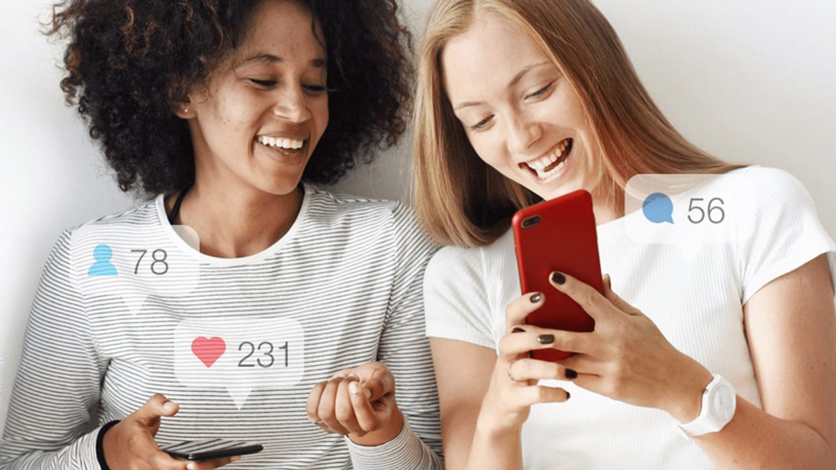 Two smiling women looking at phones with social media notification icons for likes, followers, and comments.