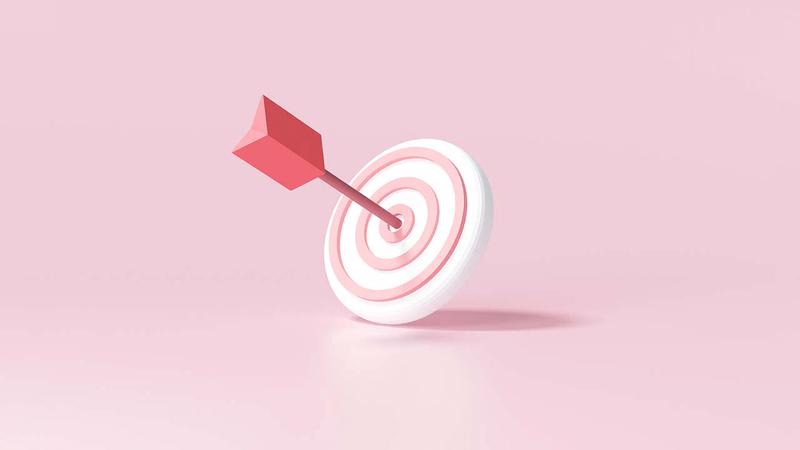 A pink arrow hits the bullseye of a pink and white target.