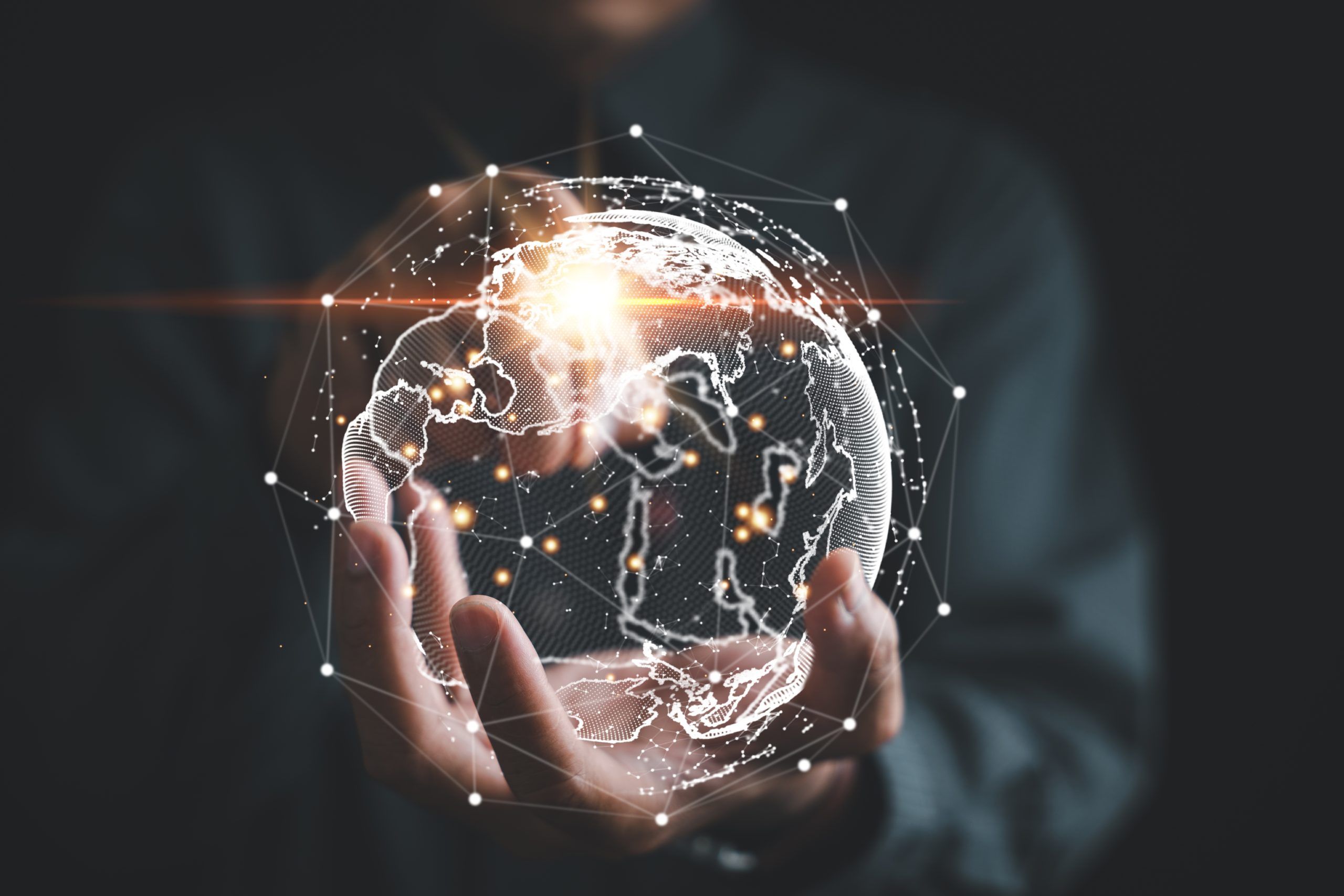 Hands holding a glowing digital globe with a network of connections.