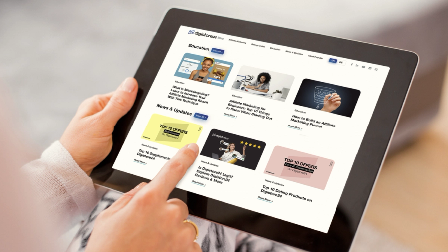 A person uses a tablet displaying the Digistore24 blog, with an article on "Top 10 Offers" highlighted.