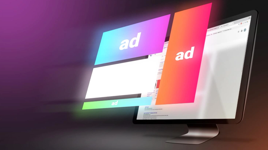 A computer monitor displaying a web page with colorful "ad" banners floating in front.