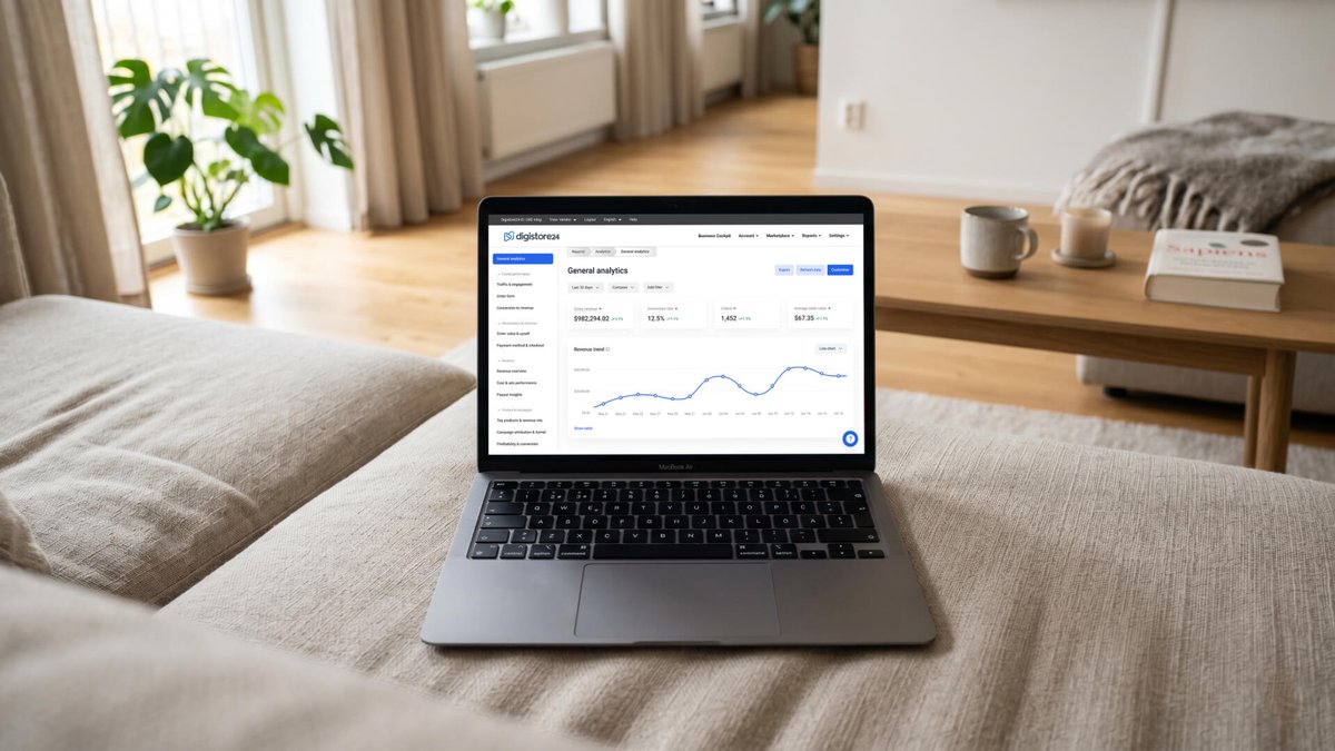 Laptop on a couch displaying an analytics dashboard.