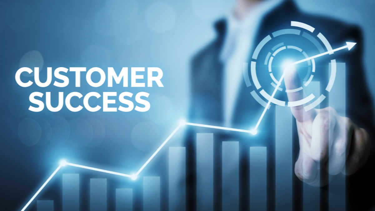 CUSTOMER SUCCESS text, a business person pointing at a glowing upward trend line over a bar graph with a tech target graphic.
