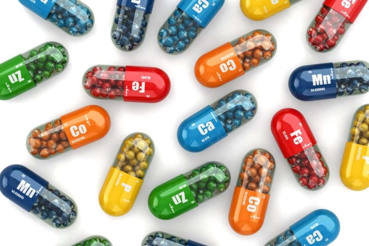 Assortment of colorful nutrient capsules, each labeled with a chemical symbol.