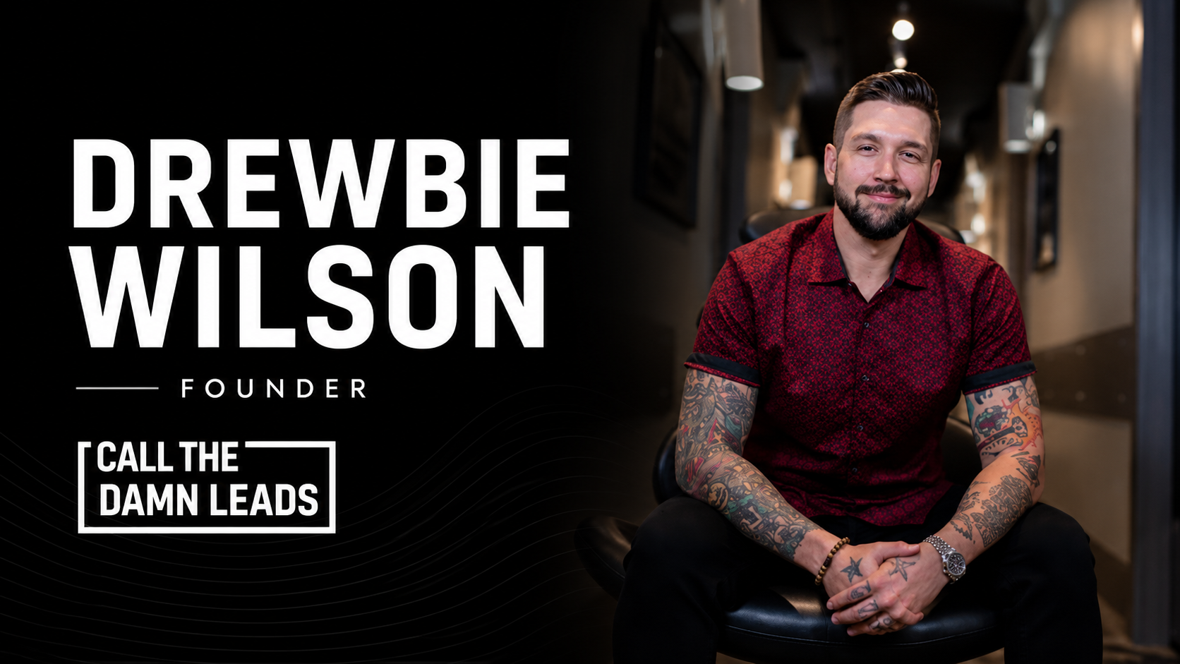 Drewbie Wilson, founder of Call The Damn Leads, smiling with tattoos in a red shirt.
