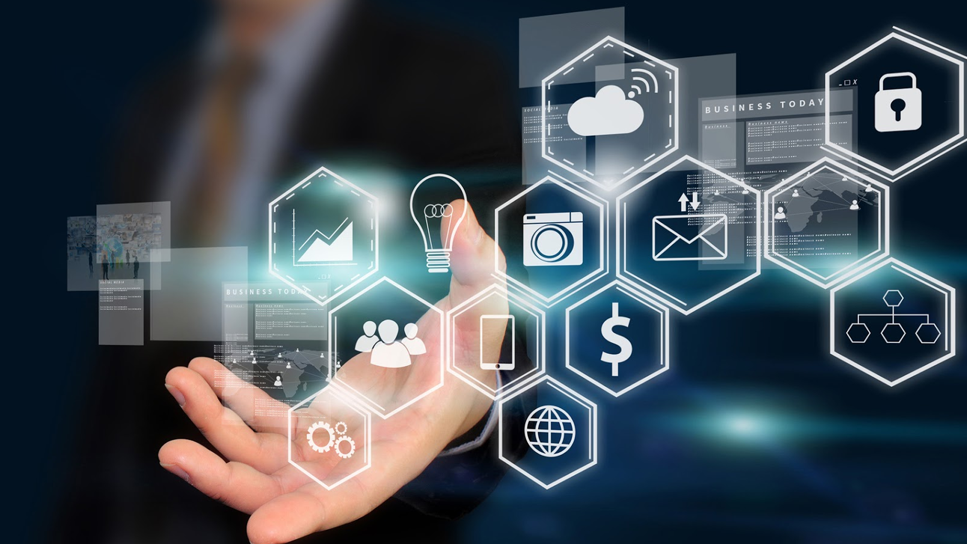 Hand presenting a holographic display of glowing business and technology icons.