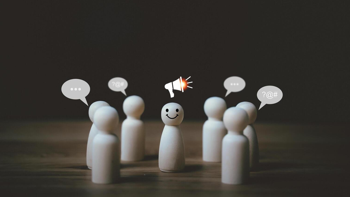 Smiley peg doll with a megaphone icon speaking to other peg dolls with speech bubbles.