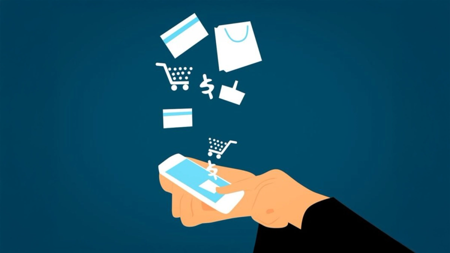A hand holding a smartphone with e-commerce icons like shopping carts, credit cards, and bags floating above it.