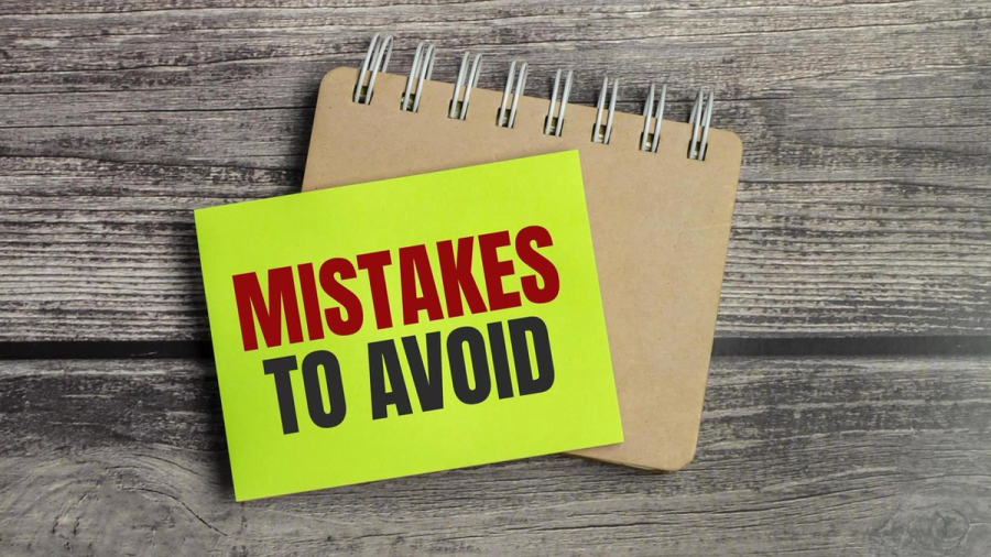 A yellow sticky note on a notebook reads "MISTAKES TO AVOID".