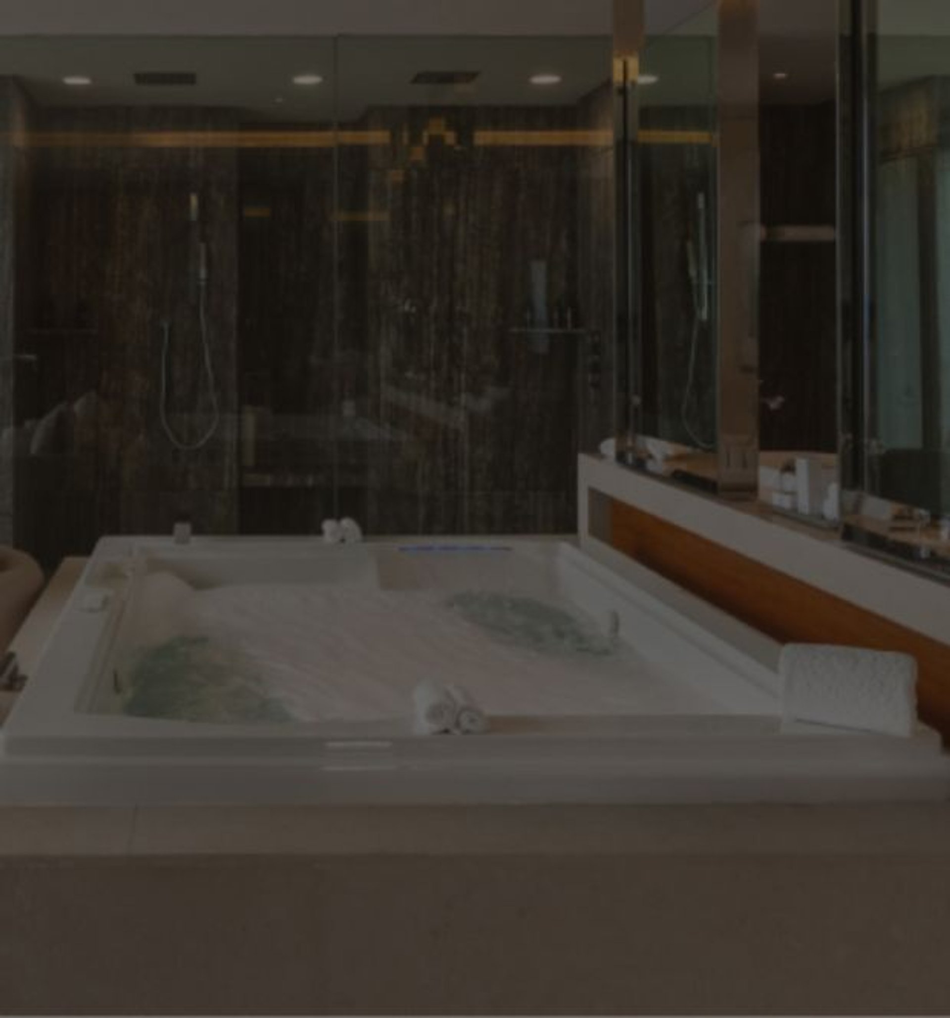 Luxurious modern suite with indoor jacuzzi and oceanfront balcony.