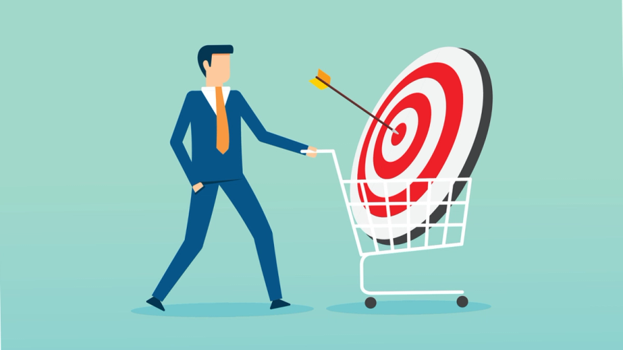 Businessman pushing a shopping cart containing a target with an arrow in the bullseye.
