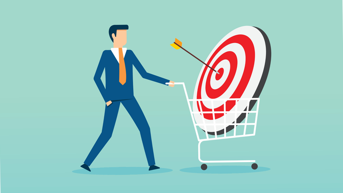 Businessman pushing a shopping cart containing a target with an arrow in the bullseye.