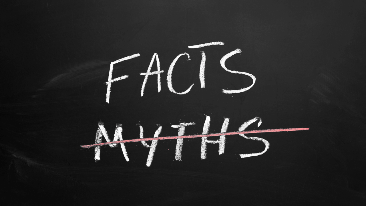 The word "FACTS" written in chalk above "MYTHS", which is crossed out with a red line on a blackboard.