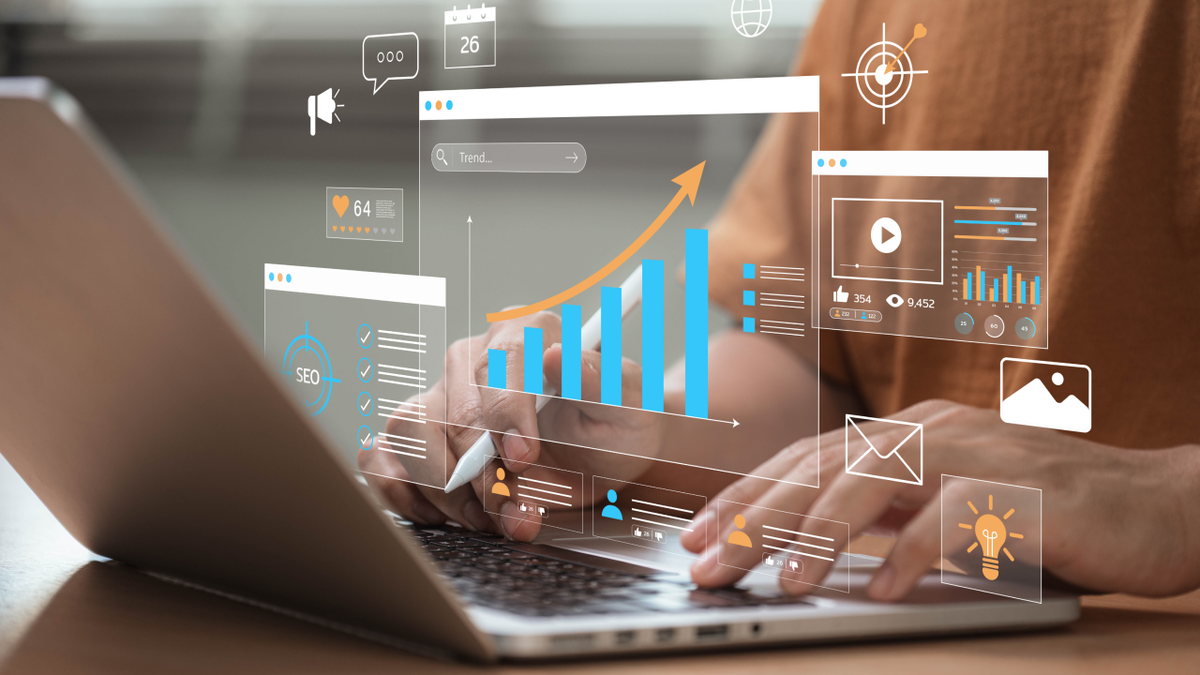 Digital marketing and business analytics displayed as virtual screens above a laptop keyboard.