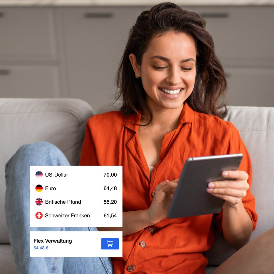 A smiling woman on a couch looks at a tablet displaying currency exchange rates and a shopping cart item.