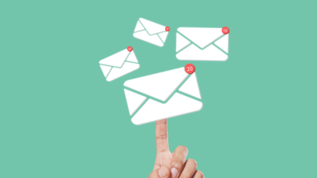 A finger balancing multiple floating email icons with unread message notifications.