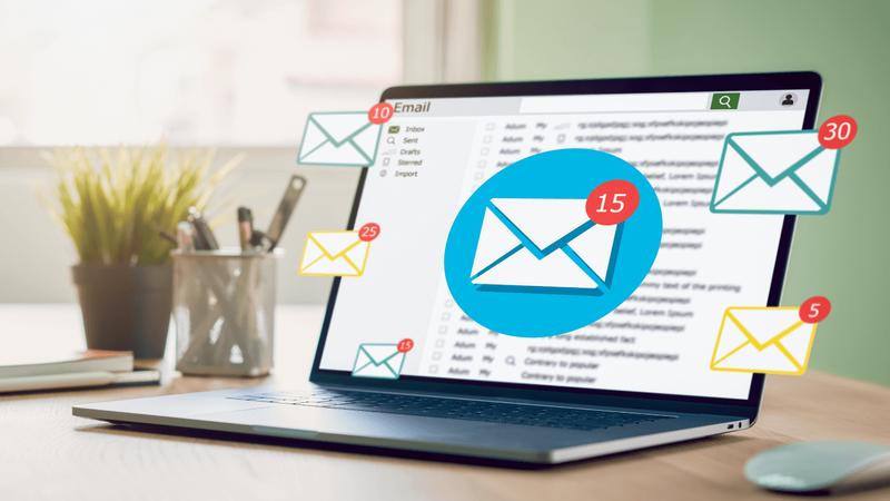 Laptop displaying an email inbox with multiple floating email notification icons.