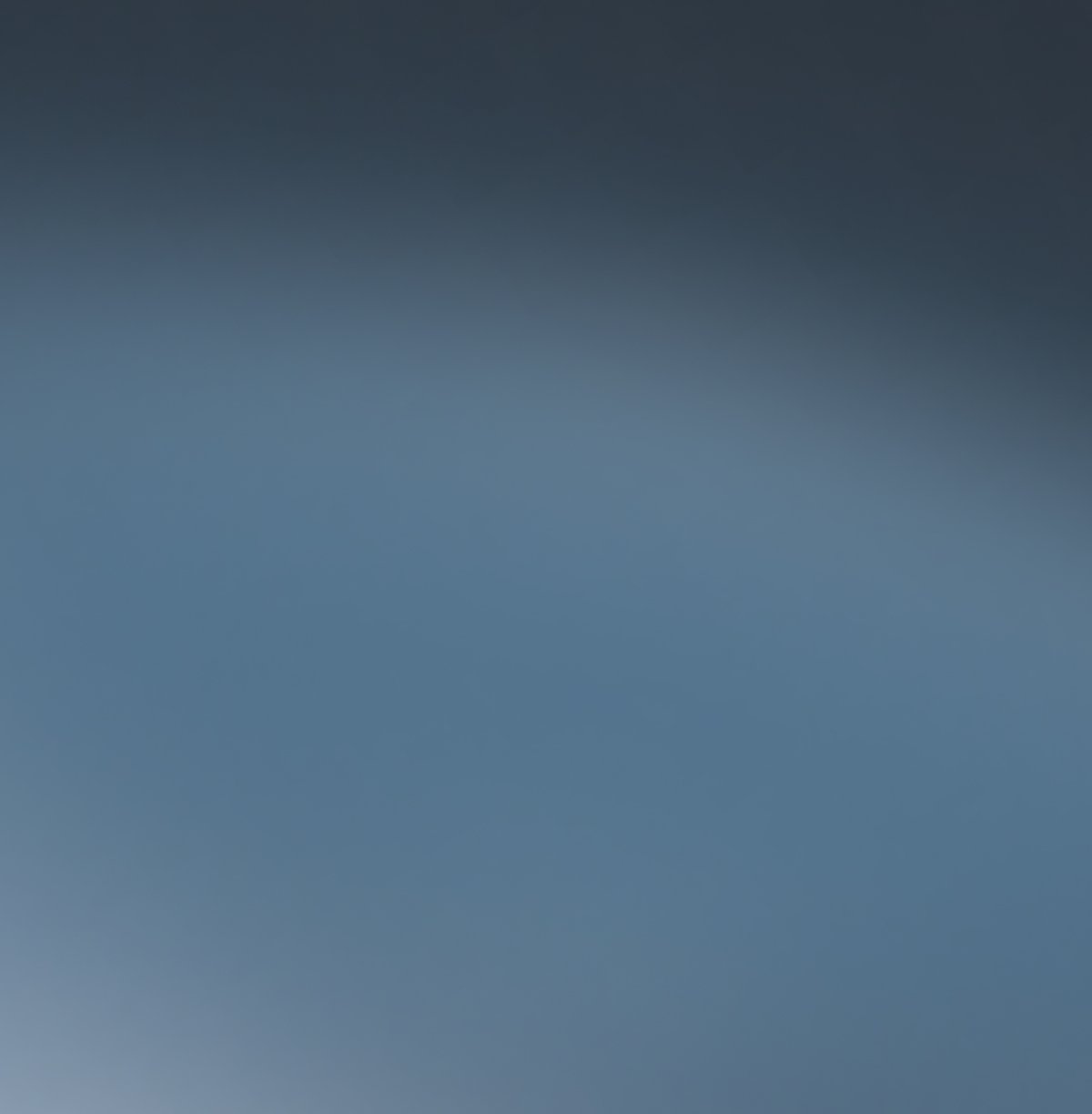 A soft blue-gray gradient background.