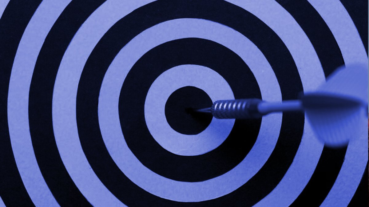 A dart hitting the bullseye of a target.