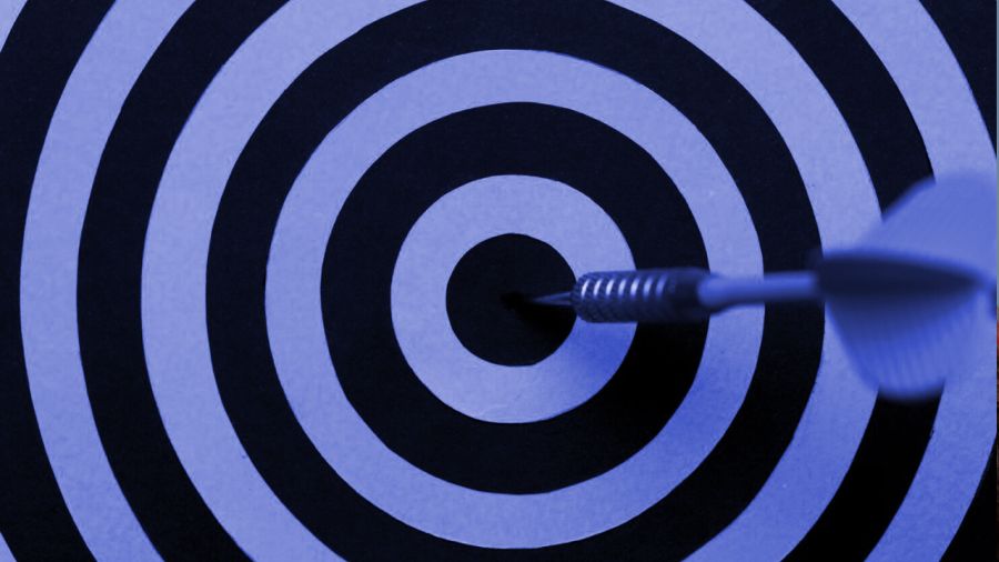 A dart hitting the bullseye of a target.
