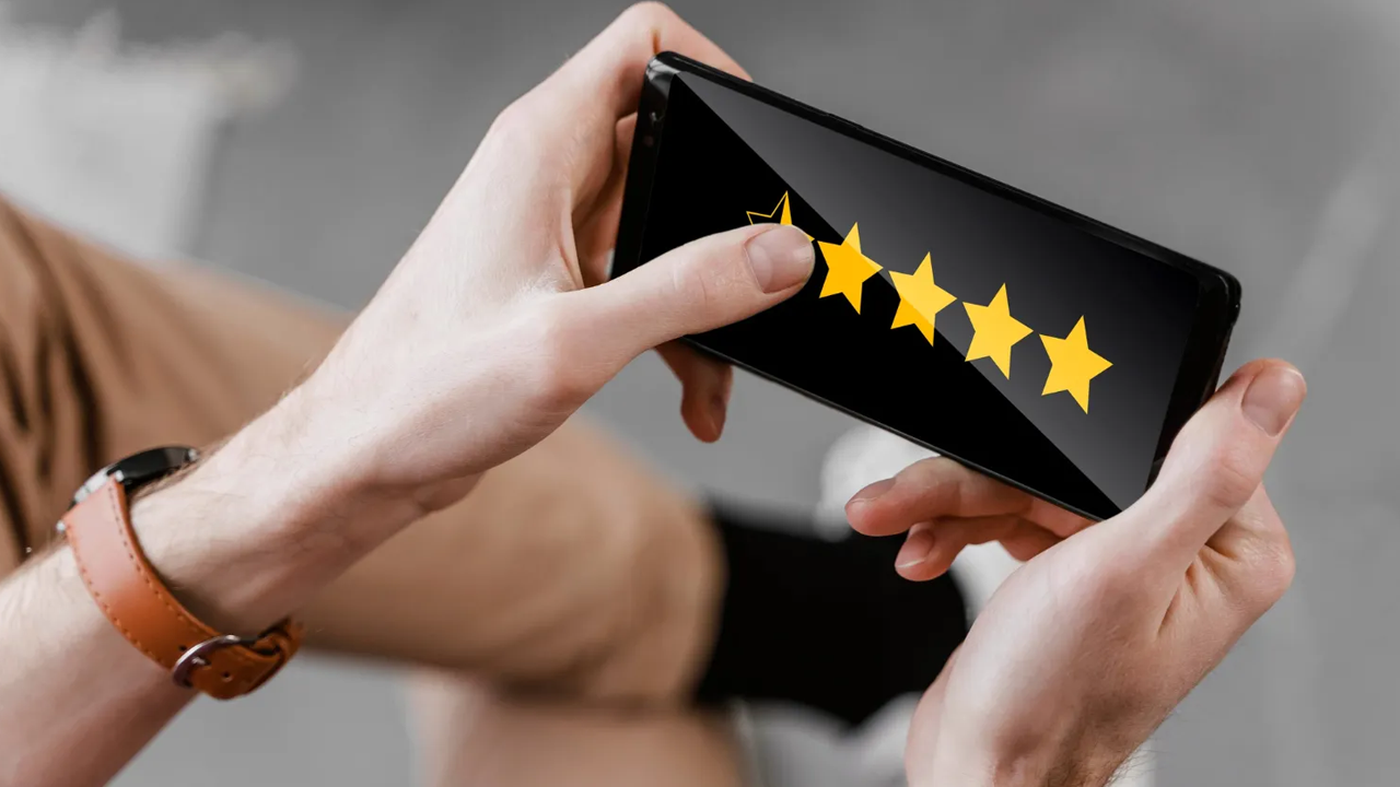 Hands selecting a star rating on a smartphone screen.