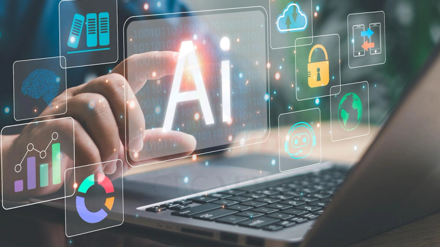 A hand touches a glowing holographic "AI" text surrounded by technology icons above a laptop.