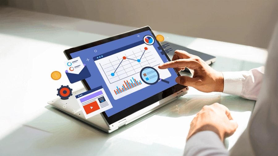 Hands touching a laptop screen displaying data analytics charts and digital marketing icons.
