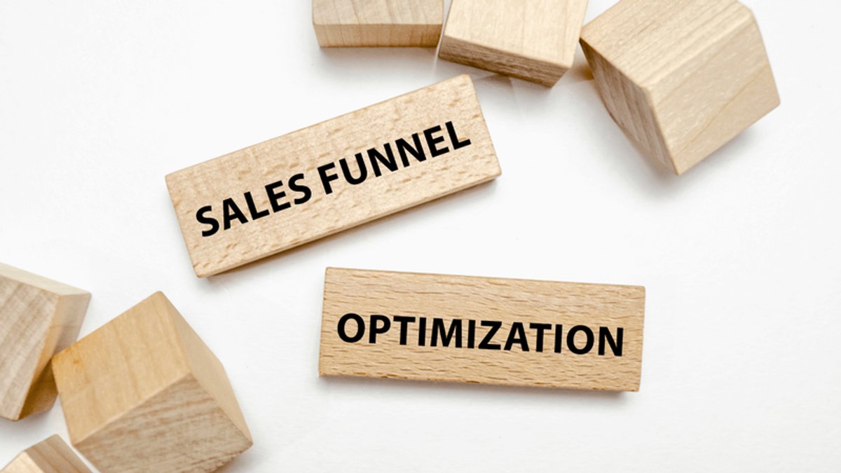 Wooden tiles spelling "SALES FUNNEL OPTIMIZATION" on a white background with other blocks.