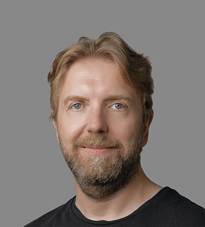 Smiling man with blonde hair and a beard.
