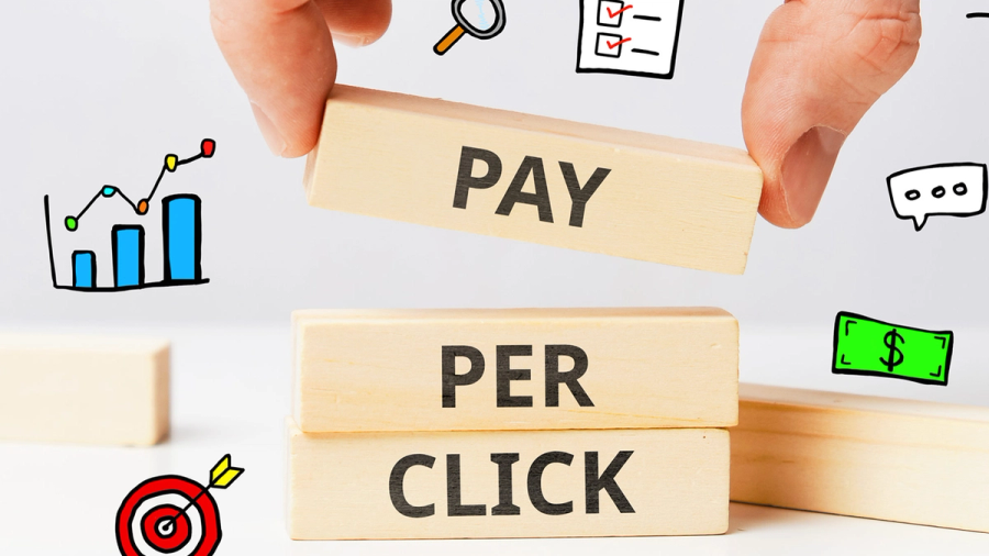 Hand stacking wooden blocks spelling "PAY PER CLICK" amid digital marketing doodles.