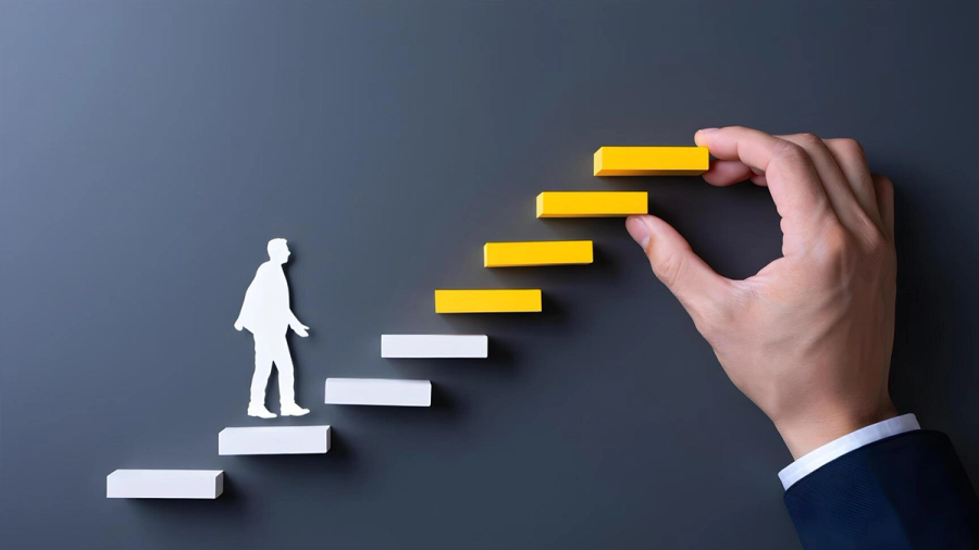 A white cutout person walks up block stairs while a hand places a yellow block as the next step.