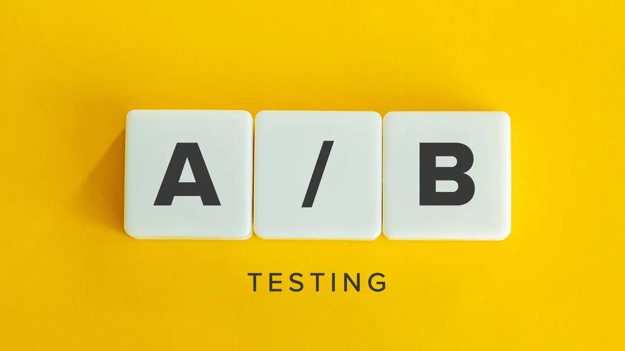 Tiles spelling "A / B" with the word "TESTING" below, on a yellow background.