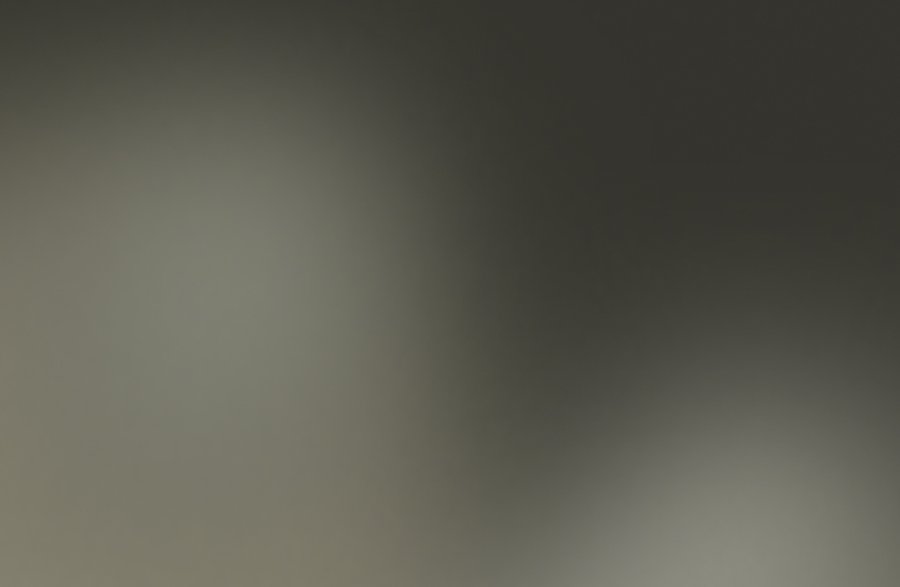 Abstract blurred background with a dark grey and greenish gradient.