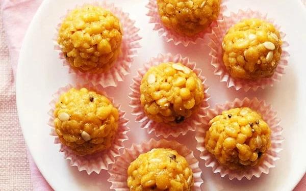 Step by step boondi ladoo recipe showing round boondi fried in oil draining on paper and being pressed into ladoo shape with oiled palms after sugar syrup soaking