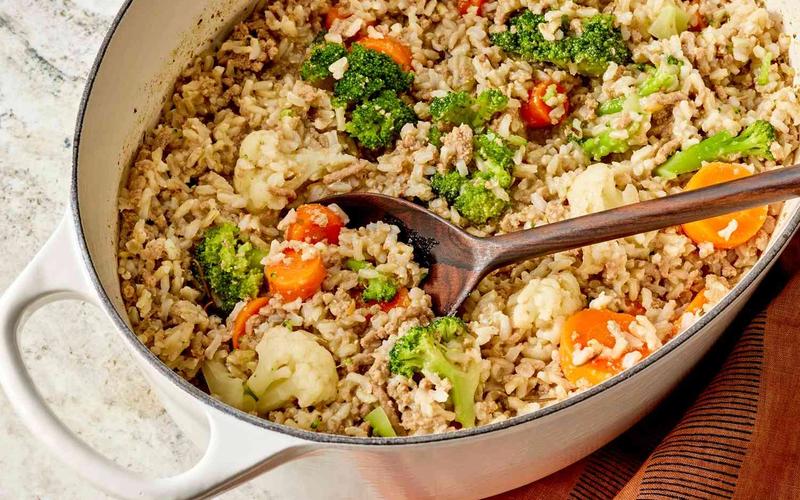 Batch cooked healthy homemade dog food with chicken rice and vegetables stored in glass containers for 3 day refrigerator supply